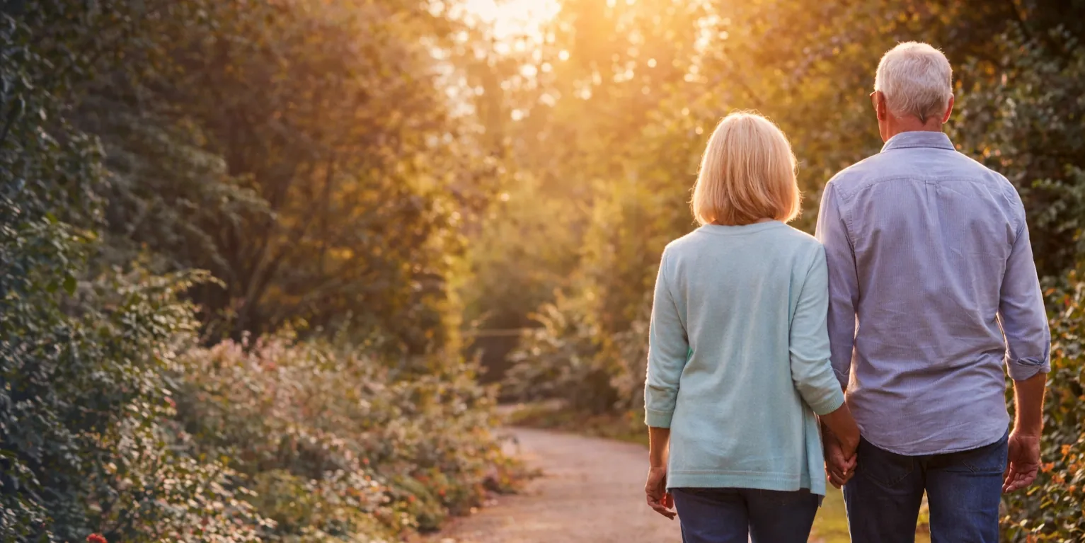 Senior couple walking in a park, later life finance guide.